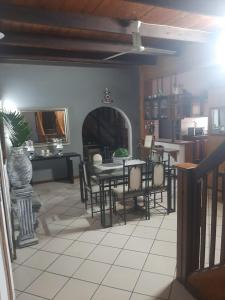 a kitchen and dining room with a table and chairs at AD'S Overnight Accommodation in Richards Bay