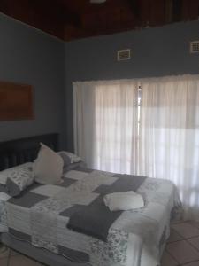 a bedroom with a bed with pillows and a window at AD'S Overnight Accommodation in Richards Bay +15 photos