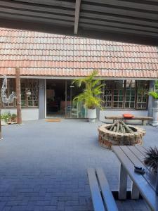 a building with benches and plants in front of it at AD'S Overnight Accommodation in Richards Bay