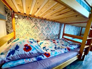 a bedroom with a bed with flowers on it at Och!hostel in Gdynia