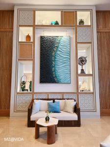 a living room with a couch and a table at Vida Marassi Marina Two Bedroom Hotel Apartment in El Alamein