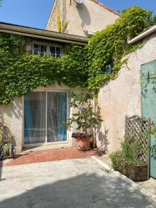 a house with ivy growing on the side of it at Large Family Home in Mediterranean France in Tourbes