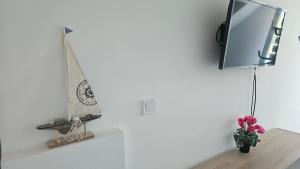 a mirror on a wall next to a shelf with a boat on it at Bagaméri Vendégház in Badacsonytomaj