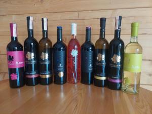 a group of wine bottles sitting on a table at Edelweiss Mountain Lodge in Brda +8 photos