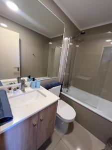 a bathroom with a sink and a toilet and a tub at Estudio centro chillán ñuble in Chillán