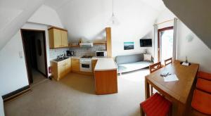 a small kitchen and living room in a house at Ferienhof Seeblick in Buchberg bei Herberstein