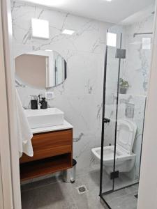 a bathroom with a sink and a toilet at קסם הכנרת in Tiberias