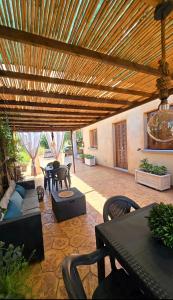 an outdoor patio with a wooden pergola at Affittacamere Il FIORE in Posada