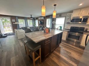 a kitchen with a large island with a counter top at Cozy cottage by the beach in Pointe-du-Chêne