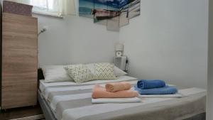 two beds with towels on them in a room at Apartman Bilandžić Drage in Drage