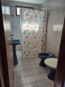 a bathroom with two toilets and a shower curtain at Las Camelias - chalet zona centro, aerosillas in Villa Carlos Paz +10 photos