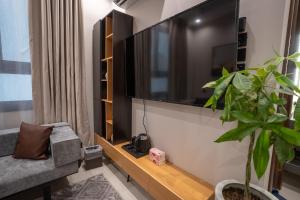 a living room with a large flat screen tv on a wall at الرابية - شقق فارهة - دخـول ذكي in Abha