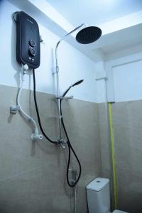 a shower in a bathroom with a shower head at SHA Waves Hikkaduwa in Hikkaduwa