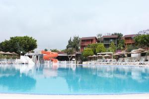 a large swimming pool with a water slide at Olbios Marina Resort Hotel in Kumkuyu