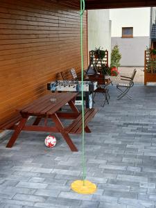 a wooden picnic table with an umbrella on a patio at Agroturystyka u Krzysztofa ZATOR ,ENERGYLANDIA , NOCLEGI in Graboszyce