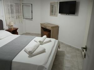a hotel room with a bed with towels on it at Stella's apartment in Mytilene