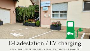 a house with an ev charging sign in front of it at Ambient Hotel am Europakanal in Fürth