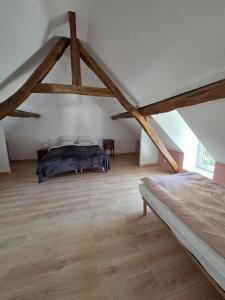 a bedroom with a bed in a attic at Maison de campagne in Saint-Bonnet-Tronçais