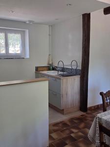 a kitchen with a sink and a counter top at Maison de campagne in Saint-Bonnet-Tronçais