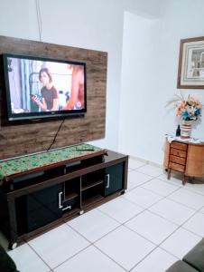 a living room with a flat screen tv on a wall at Riviera imóveis in Campo Grande