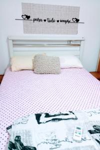 a bed with a hello kitty blanket on it at Riviera imóveis in Campo Grande
