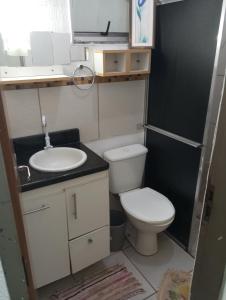 a small bathroom with a toilet and a sink at Riviera imóveis in Campo Grande