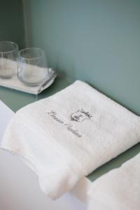 a white napkin with the words novation on a table with glasses at Donna Paolina Rooms & Apartments in Villammare