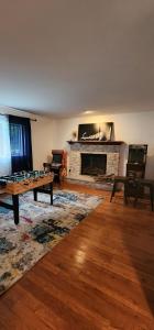 a living room with a table and a fireplace at Deer Chalet in the heart of Pocono in Tobyhanna