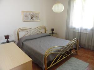 a bedroom with a bed and a table and a window at Poggio Novello in Peccioli