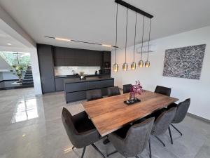 a dining room with a wooden table and chairs at Villa Lustria in Labin +44 photos