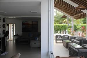 a living room with a couch and chairs and a table at Casa Luxuosa - Porto de Galinhas in Porto De Galinhas