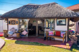 a hut with a bench in a yard at Terry's Cozy Haven in Germiston