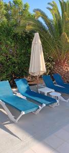 a group of lounge chairs and an umbrella at Casa Jaime in Puerto del Carmen +26 photos