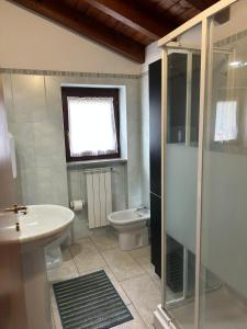 a bathroom with a shower and a sink and a toilet at MXP apartment, shuttle service, parking free in Cardano al Campo +6 photos