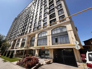 a tall building with a lot of windows at Etno Naz in Bishkek