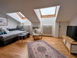 a living room with a couch and a tv at Nona 4 Seefeld in Seefeld in Tirol