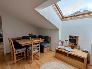 a room with a table and a dining room with a skylight at Nona 4 Seefeld in Seefeld in Tirol