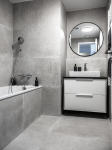 a bathroom with a sink and a mirror at City View Apartment in SKY PARK by Zaha Hadid in Nivy +32 photos