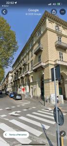 a large building on a city street with a crosswalk at Turin Central Carlo Felice in Turin +62 photos
