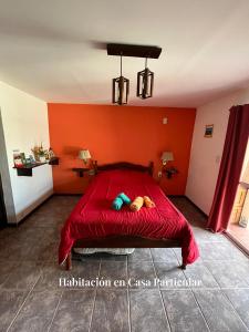 a red bed with a stuffed animal laying on it at Refugio del Alma in San Rafael