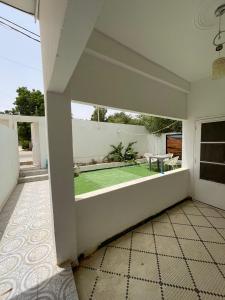 a room with a patio with a green lawn at Saada Apartments in Nouakchott