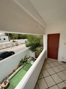 a balcony of a house with a red door at Saada Apartments in Nouakchott +3 photos
