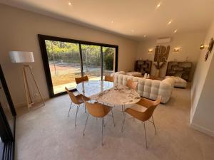 a living room with a table and chairs and a couch at Villa Pavone in Angoulême
