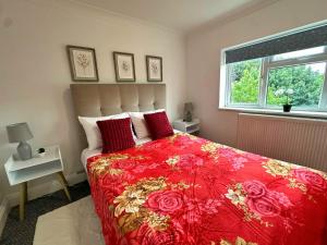 a bedroom with a red bed with red pillows and a window at New York Ensuite Double Room in London +32 photos