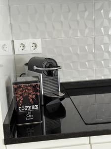 a coffee machine sitting on a counter in a bathroom at Apartamento del Puente in Autol
