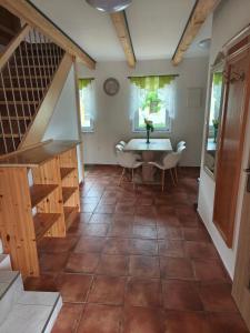 a dining room with a table and a staircase at Penzion u Bohdy in Jaroslavice