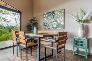 a dining room with a table and chairs at Getaway & Ocean Breeze - Secluded & Natural Charming - 2 bedrooms in Barú