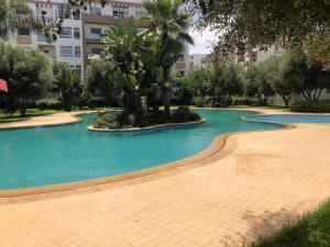 a swimming pool in front of a building at Apartment Galia Mohammedia in Mohammedia