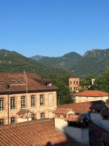 a group of buildings with mountains in the background at Sui tetti di Schio - Apartments guest house in Schio