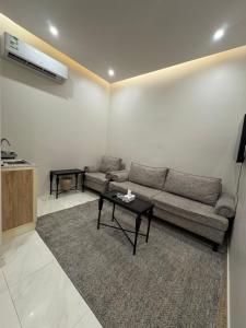 a living room with a couch and a table at غرفة وحمام مفروشة in Riyadh